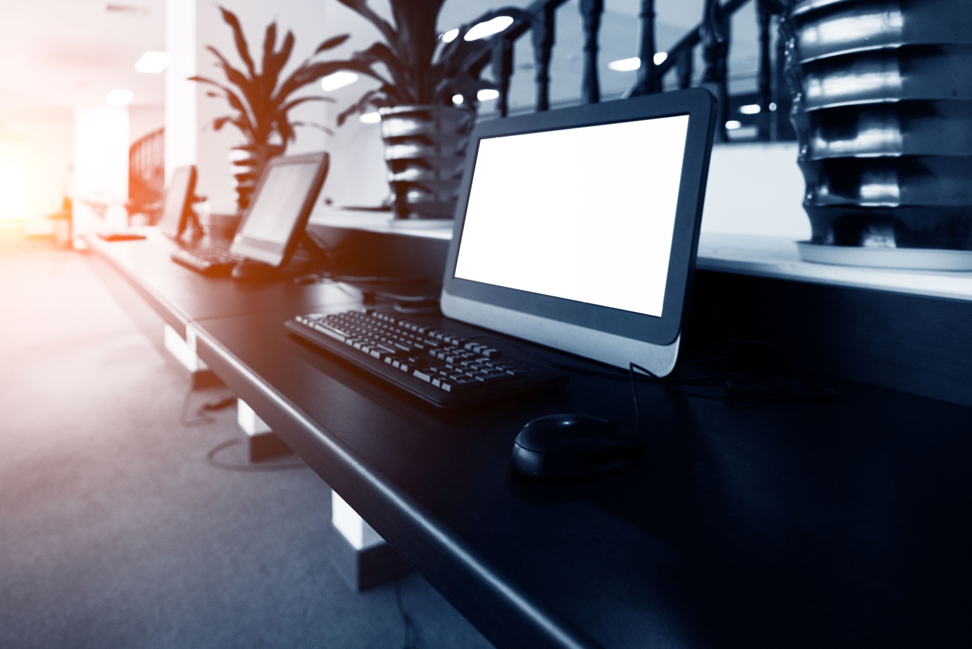 A row of computers on desk